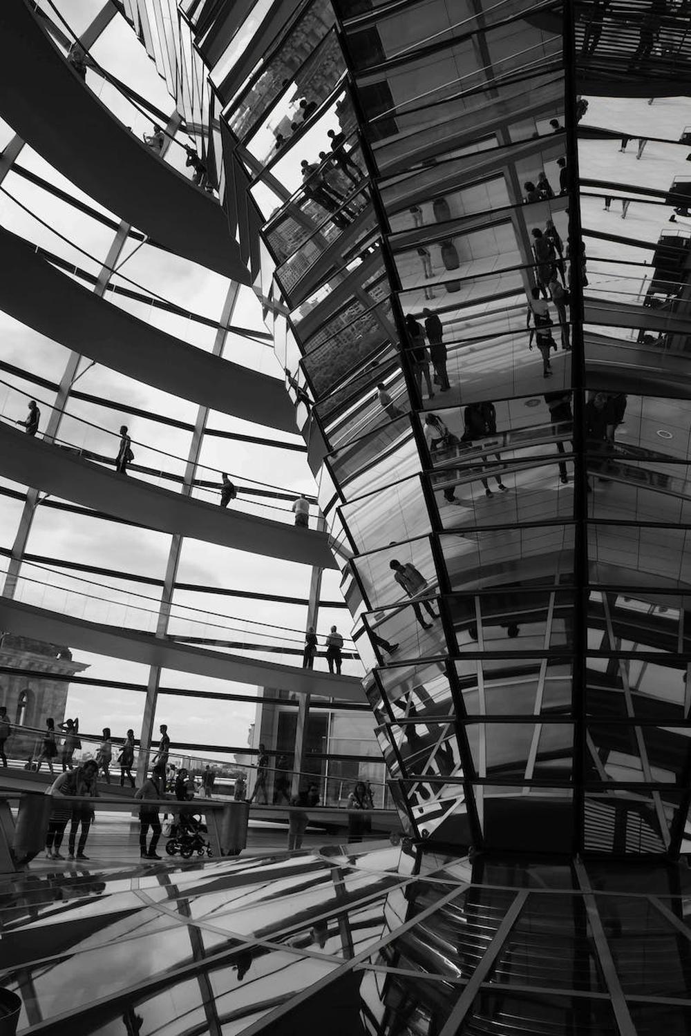 grayscale_photo_of_people_inside_a_glass_building