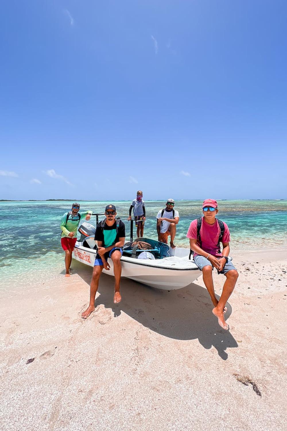 group_of_tourist_posing_with_a_boat