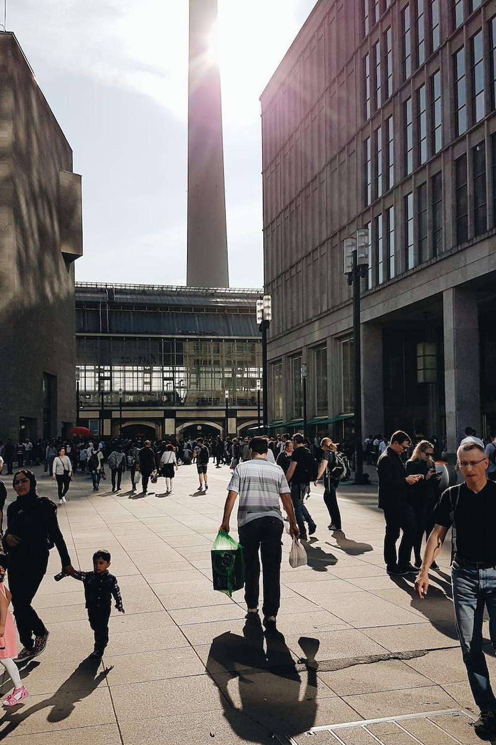 man_in_black_crew_neck_t_shirt_walking_near_buildi