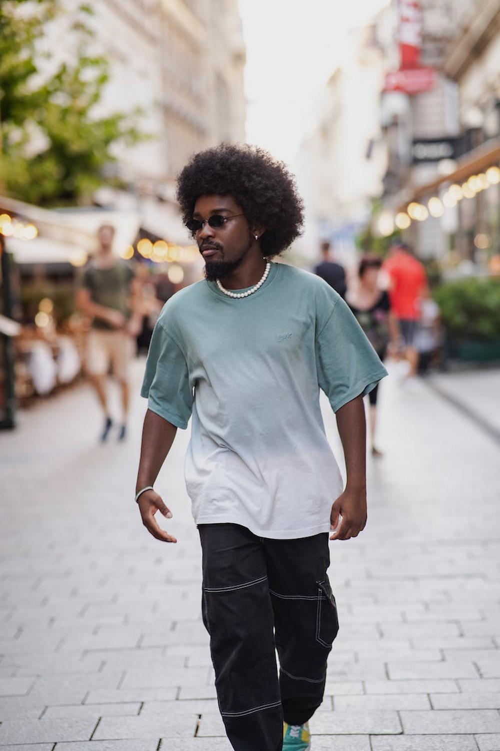 man_walking_down_a_cobblestone_alley