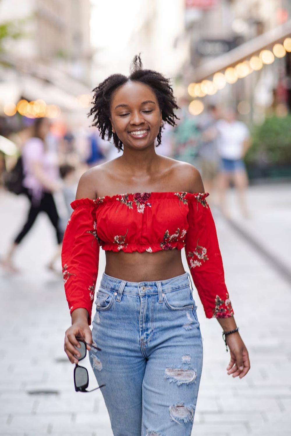 young_smiling_tourist_walking_down_the_city_promen